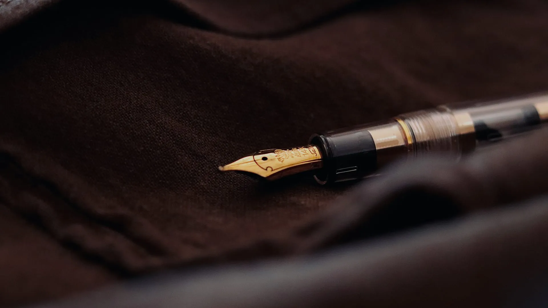A fountain pen resting on dark linen, ready for the day's work