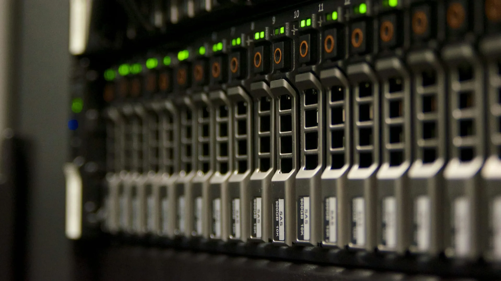 A network rack with server lights illuminated, behind a clean cable management